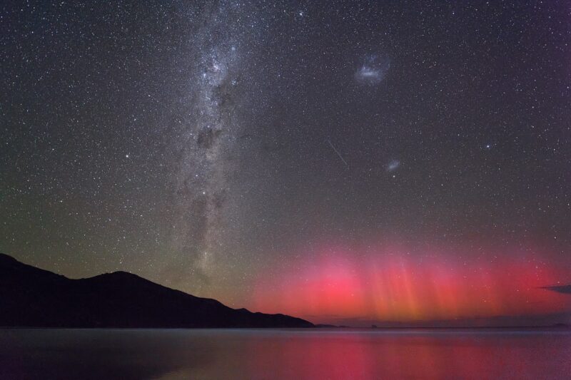 Milky Way reflected in a still mountain lake under a star-filled sky