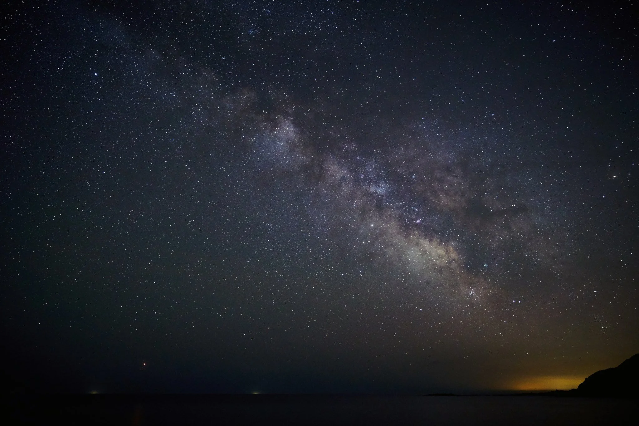 The Milky Way galaxy band arching across a dark night sky as seen from Earth